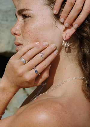 model wearing small silver wavy stud earring