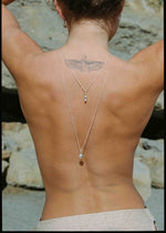 model wearing long silver necklaces