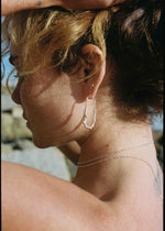 model wearing long oval hoops