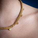 Model with braid silk necklace with circular pendants