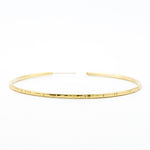 big brass hoop earring on white background