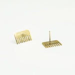 brass comb shaped mini stud earrings on white background