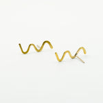 wavy stud earrings on white background
