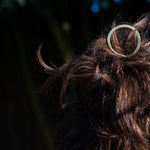 model wearing brass hair pin with striped texture