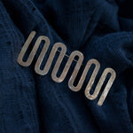 brass pin on blue scarf