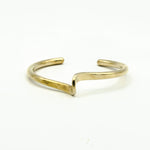 hand forged brass cuff on white background