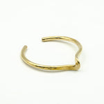 hand forged brass cuff on white background