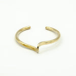 hand forged brass cuff on white background