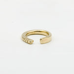 front view of hand forged brass ring with three notches