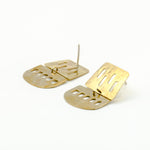 cutout brass sheet dangle earrings on white background