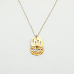 close up of brass cutout sheet necklace