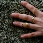 model wearing hand forged curved brass ring