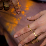 model wearing hand forged brass rings