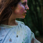 model wearing brass cutout sheet pendant on silver chain necklace