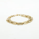 cutout brass pieces bracelet on white background