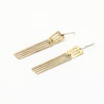 long dangly earrings laying flat on white background