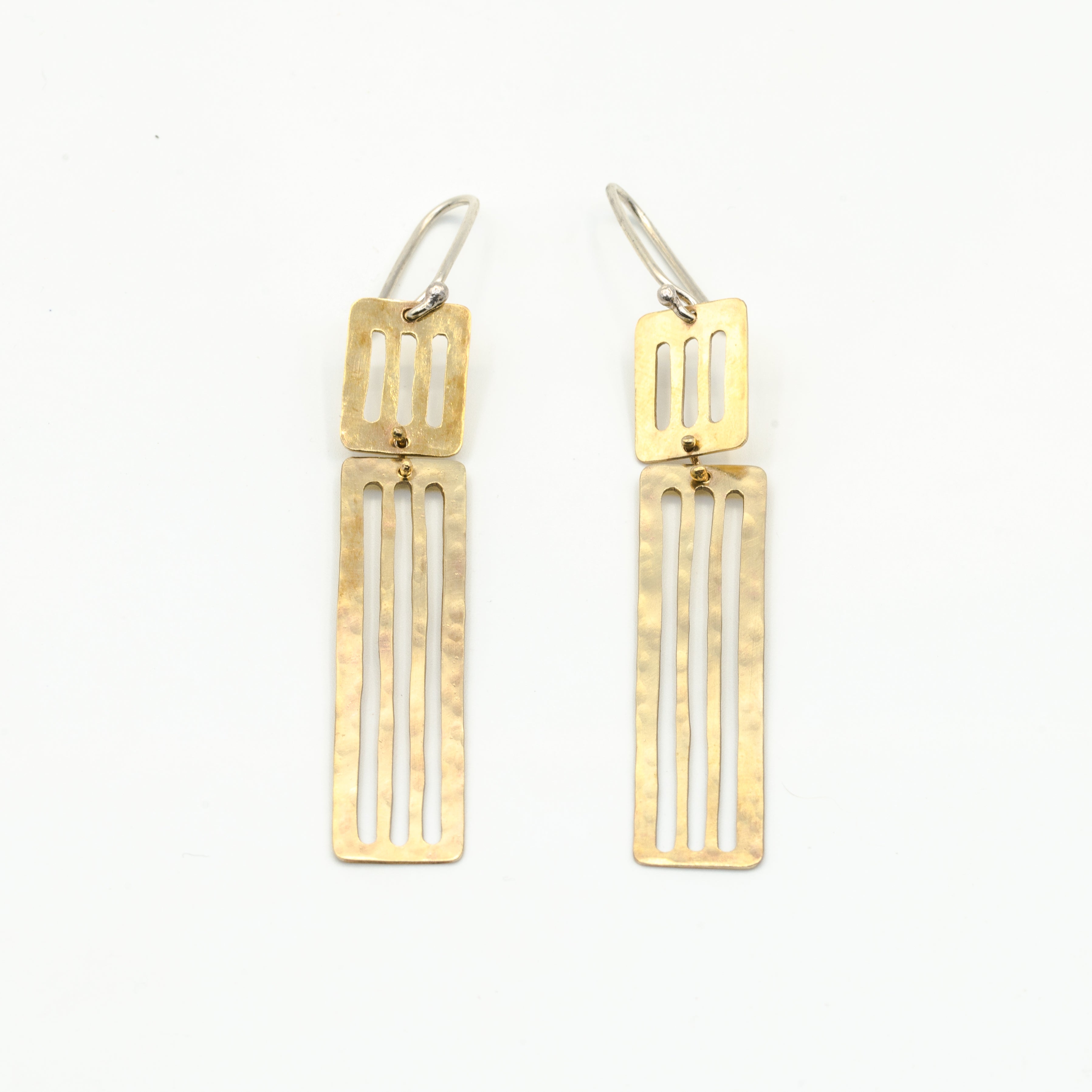 long dangly earrings laying flat on white background