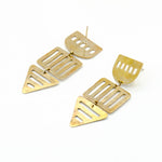 long brass geometric cutout earrings on white background