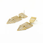 long brass geometric cutout earrings on white background