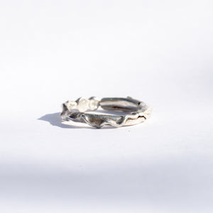 anel de prata com texturas orgânicas