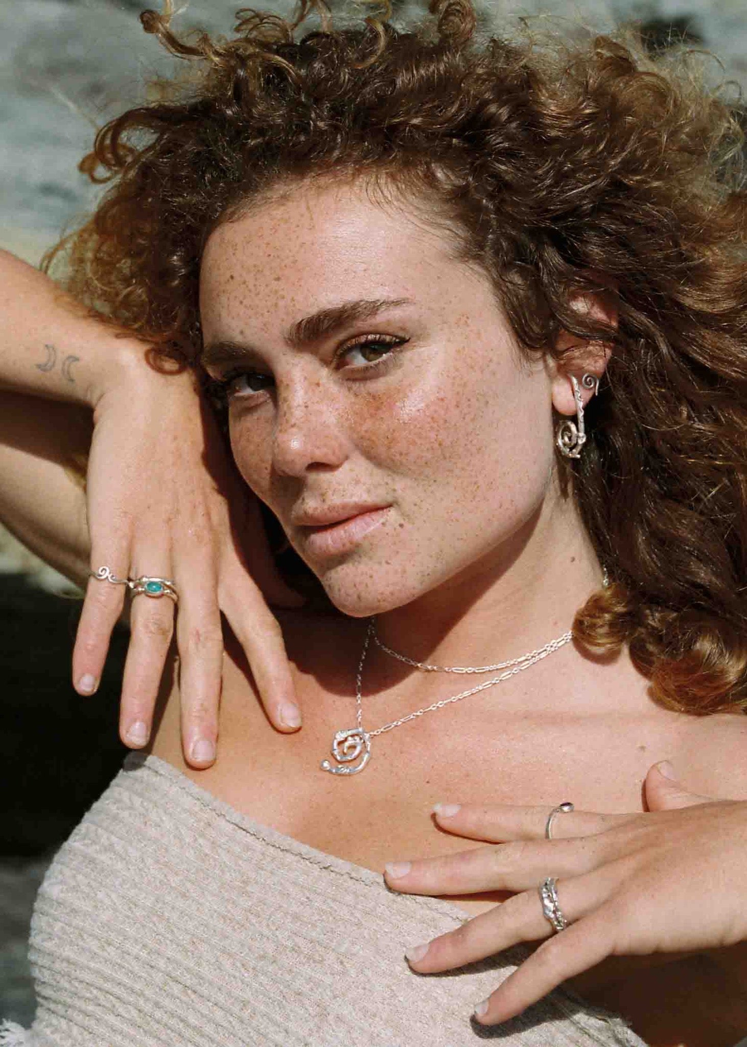 model wearing silver jewelry