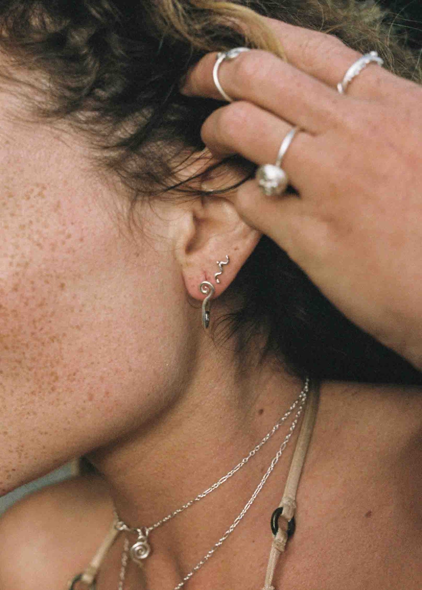 model wearing silver jewelry