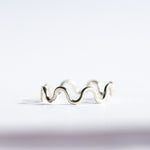 Silver wavy ring on a white background