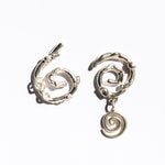 Silver asymmetrical spiral earrings on a white background