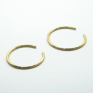 thick brass cuffs with balled ends on white background, sizes small and big