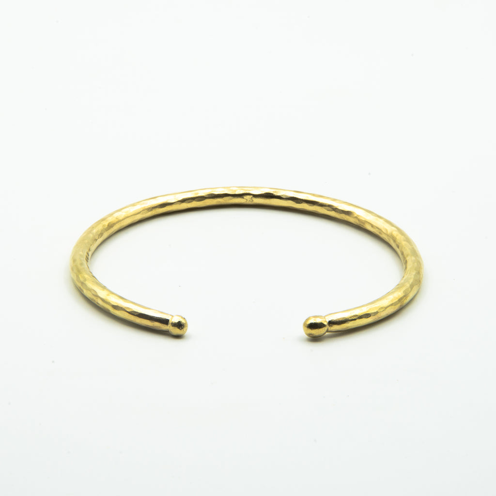 thick brass cuff with balled ends, front view on white background