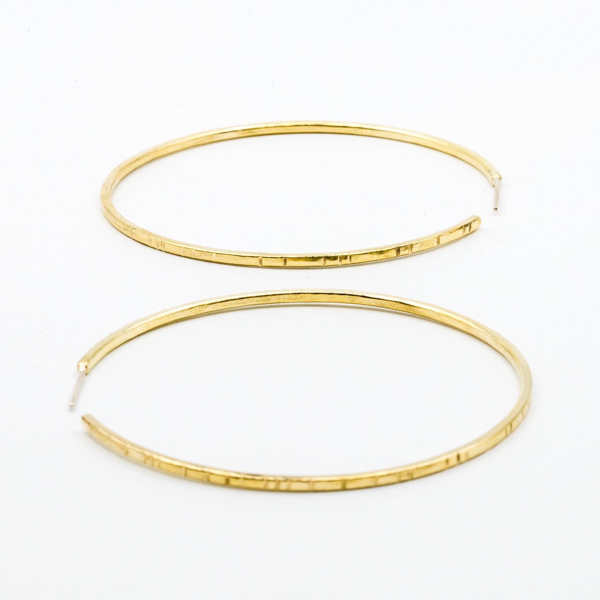 big brass hoops on white background