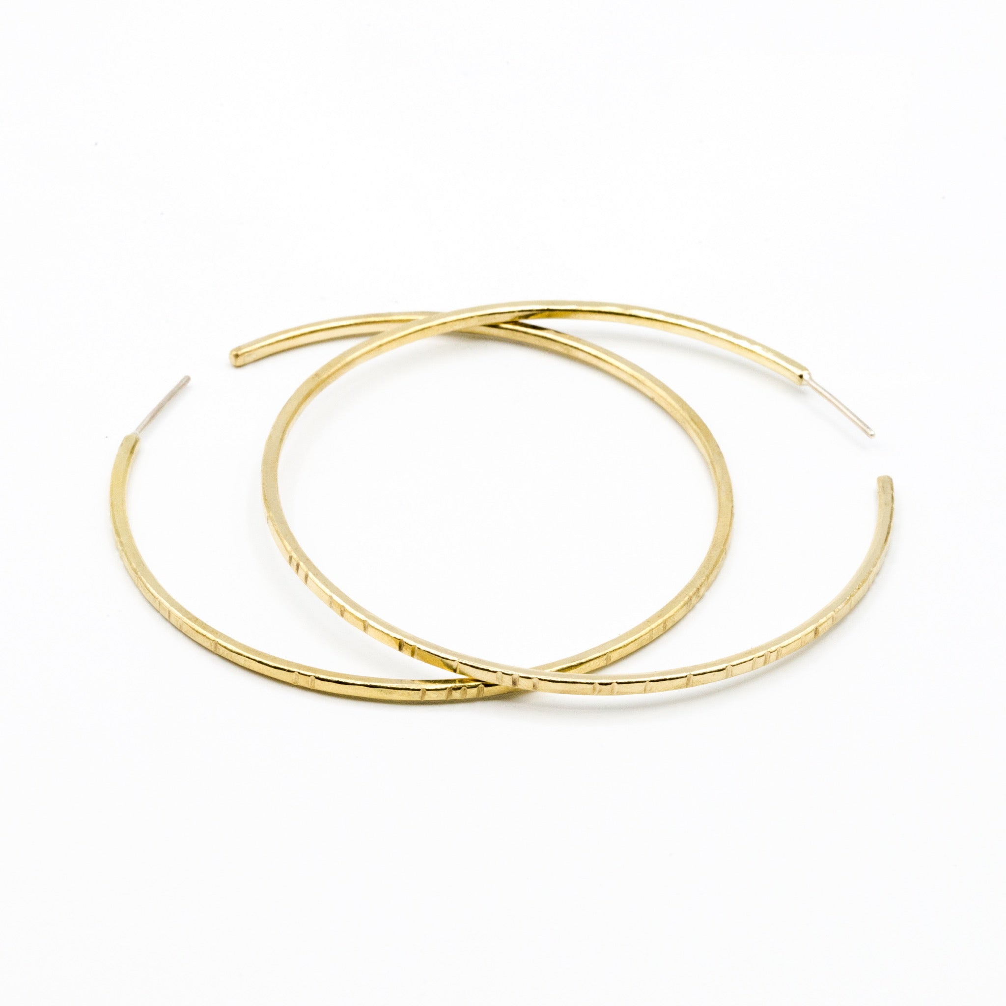 big brass hoops on white background