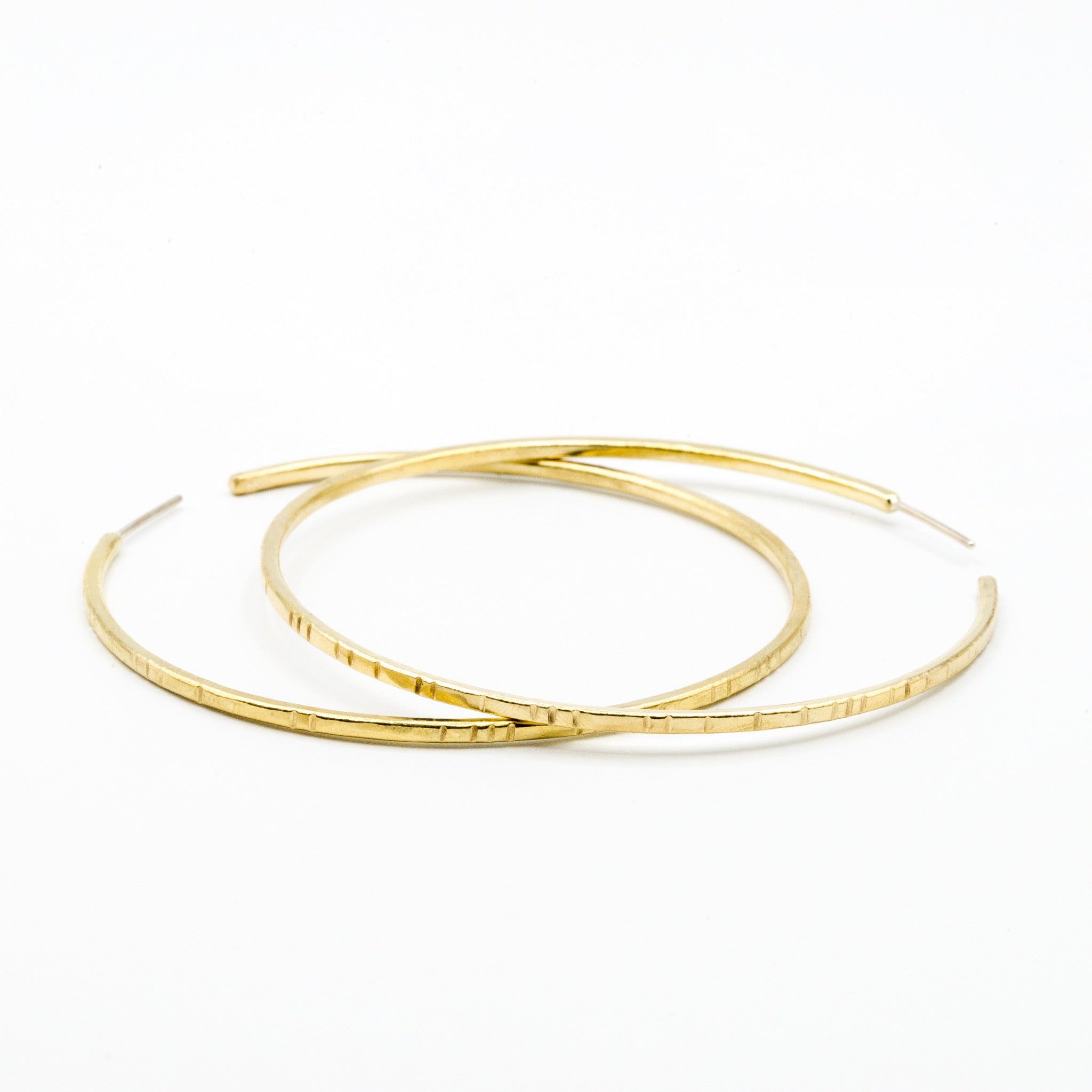 big brass hoops on white background
