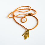 Orange silk rope necklace with brass pendants
