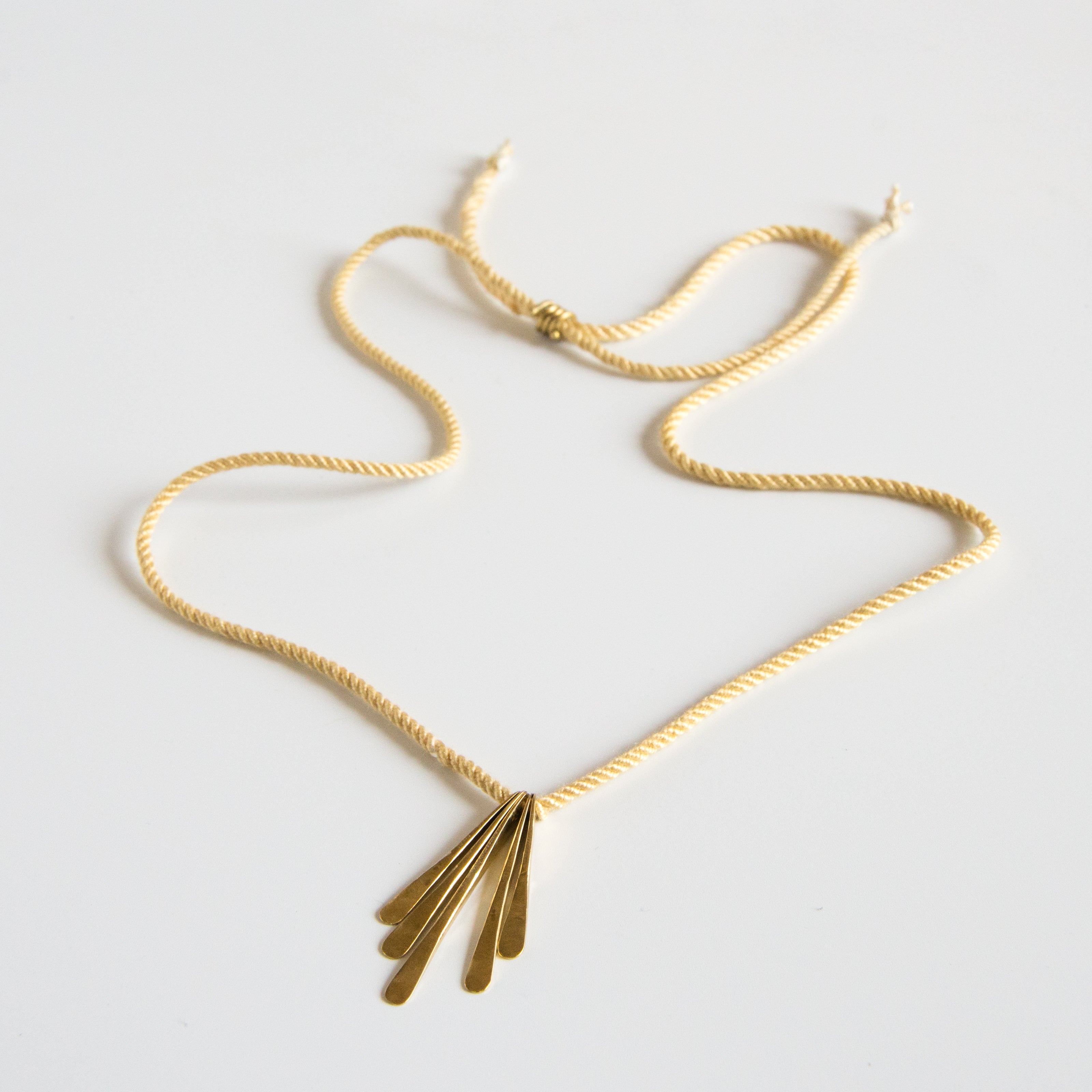 Yellow silk rope necklace with brass pendants