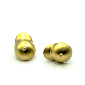 boobie shaped brass earrings on which background