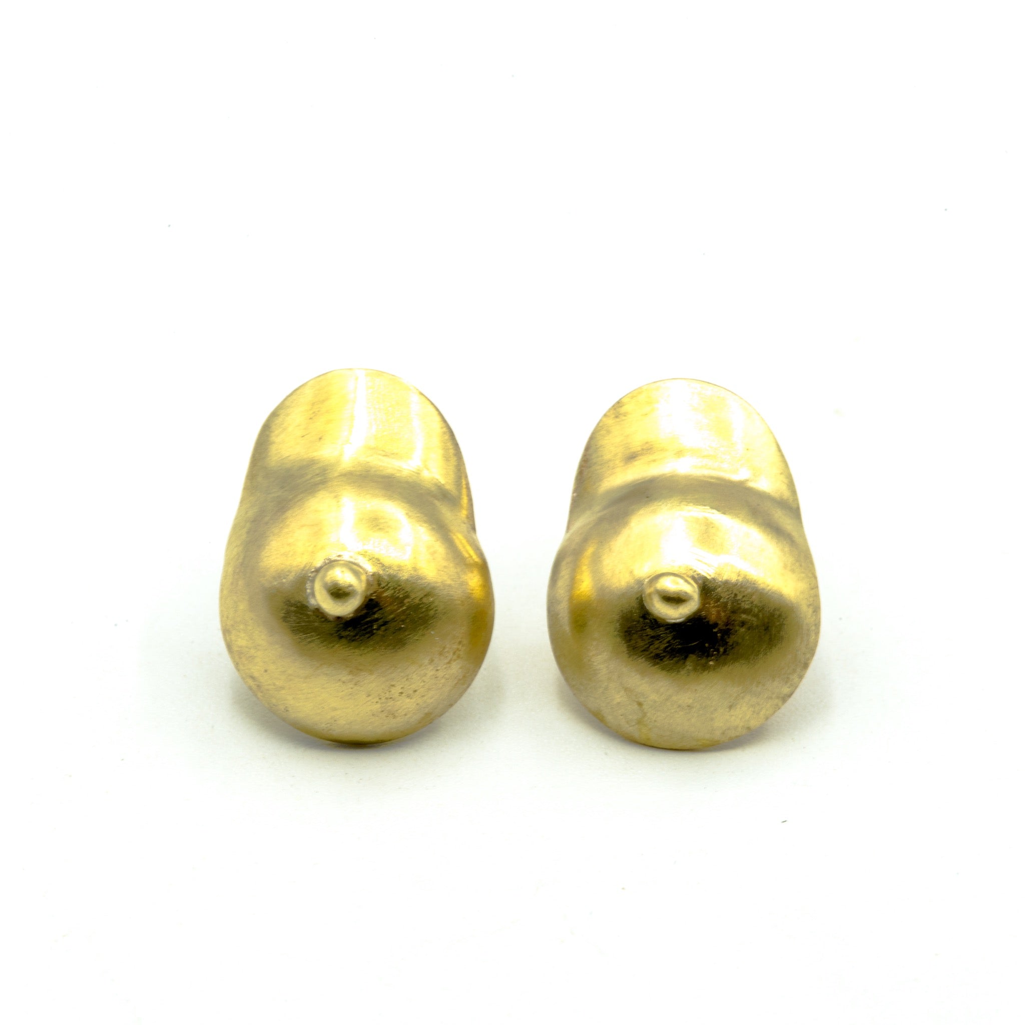 boobie shaped brass earrings on which background