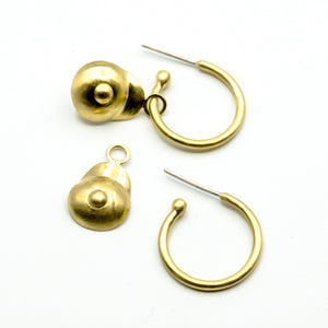 boobie shaped brass dangly hoops on white background 