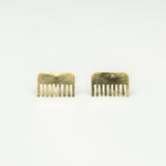 brass comb shaped mini stud earrings on white background