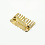 brass comb shaped pin back on white background