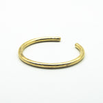 thick brass cuff back view on white background