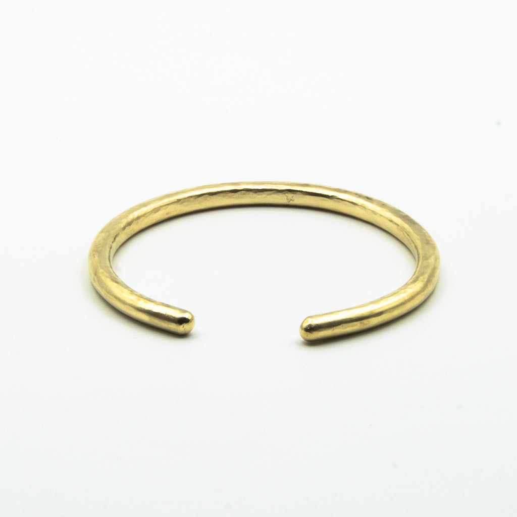 thick brass cuff front view on white background