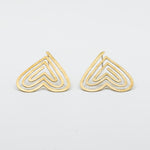 angled view heart shaped stud earrings on white background