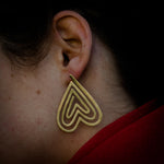 model wearing heart shaped stud earrings 