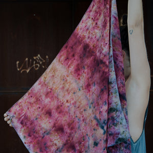 Model holding naturally dyed orange and pink silk scarf
