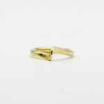 hand forged curved brass ring on white background