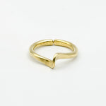 top view of hand forged curved brass ring on white background