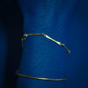 Model using delicate brass and silver bracelet