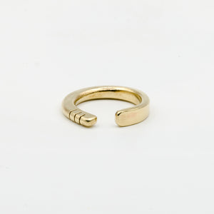 front view of hand forged brass ring with three notches