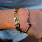 Model wearing articulated brass sheet bracelet